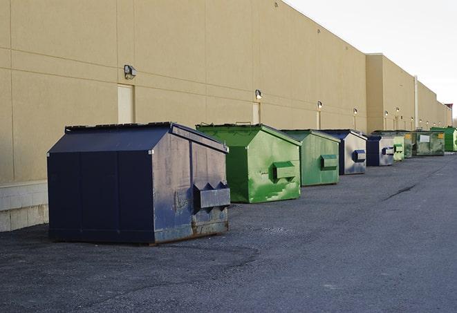 bright yellow construction dumpster full of discarded materials in Bingham Farms